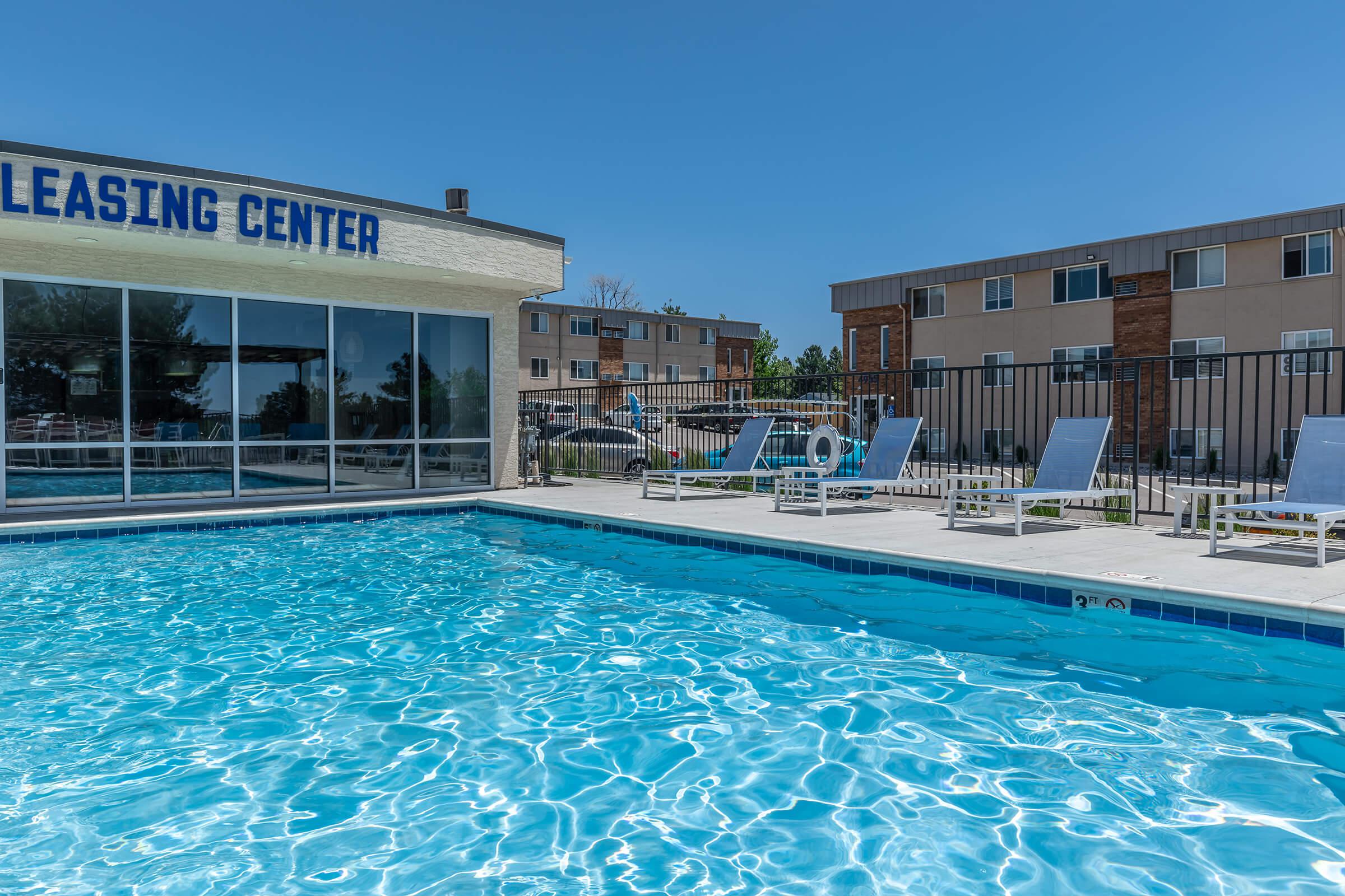 Swimming pool with lounge chairs at North 49 Apartments, located in Colorado Springs, CO