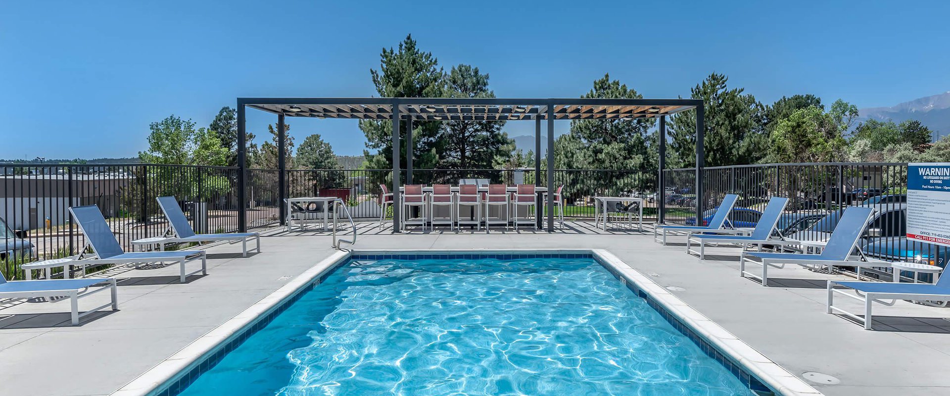 Swimming pool with lounge chairs at North 49 Apartments, located in Colorado Springs, CO 4
